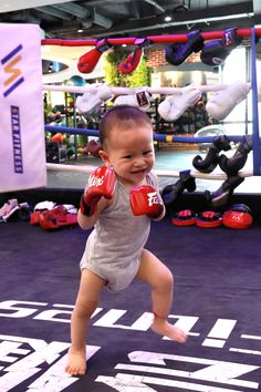 a baby with boxing gloves on running through the ring