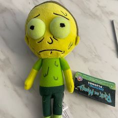 a stuffed toy is sitting on a table next to a card and pen with the character rick