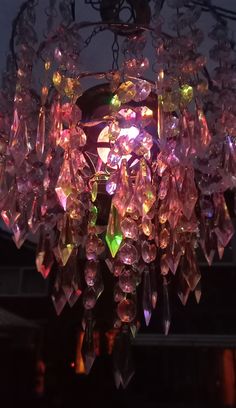 a chandelier hanging from the ceiling with lots of lights on top of it