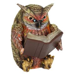 an owl figurine is reading a book