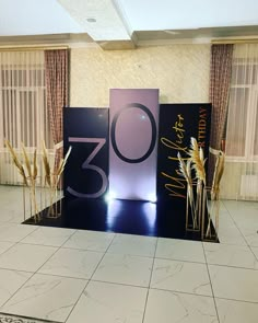 an image of a stage set up for a 30th birthday party with flowers and candles