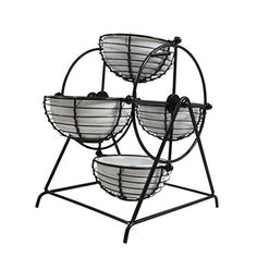 three metal baskets sitting on top of each other in a stand with two white bowls