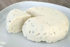 two pieces of cheese sitting on top of a white plate