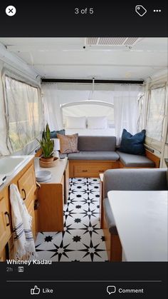 the interior of a mobile home with kitchenette and living room in it's center