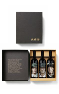 three bottles of wine in a box with the words matsu printed on one side