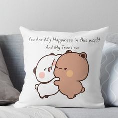 a pillow that has a teddy bear hugging it's face