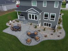 an aerial view of a house with patio furniture