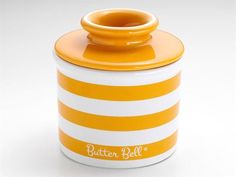 an orange and white striped canister with the word butter bell on it