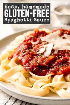 a white plate topped with pasta covered in sauce and parmesan cheese text reads easy, homemade gluten - free spaghetti sauce