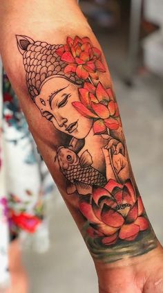 a person with a tattoo on their arm holding a fish and lotus flowers in front of them