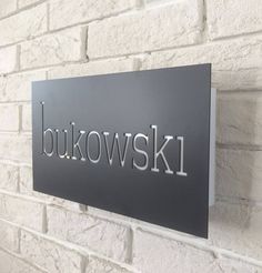 a sign on the wall that says bukowski