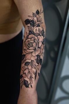 a woman's arm with flowers on it