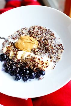 a white plate topped with blueberries and granola