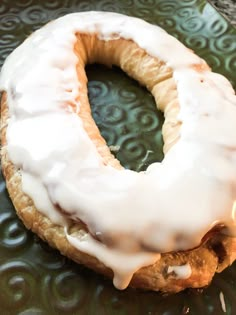 a glazed donut sitting on top of a green plate