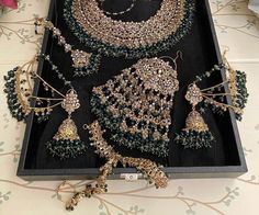 DELIVERY TIME IS ESTIMATED AT 6 TO 8 WEEKS. IF YOU REQUIRE URGENT ASSISTANCE, PLEASE CONTACT OUR CUSTOMER SERVICE TEAM.  PLEASE NOTE: COLORS CAN BE CUSTOMIZED, AND INDIVIDUAL PIECES OF JEWELRY ARE AVAILABLE FOR PURCHASE. THANK YOU!  ~ 5Pcs Green Indian/Pakistani Bridal Choker Set! Add a touch of elegance to your bridal look with this stunning 5Pcs Green Indian/Pakistani Bridal Choker Set!  Crafted with intricate details and adorned with beautiful green stones, this gold-plated jewelry set is per Pakistani Bridal Green Jewellery, Green Jewellery Indian Bridal, Green Bridal Jewellery Set, Green Bridal Jewellery, Kundan Bridal Set, Bridal Choker Set, Emerald Green Jewelry, Bridal Jewellery Set, Pakistani Bridal Jewelry