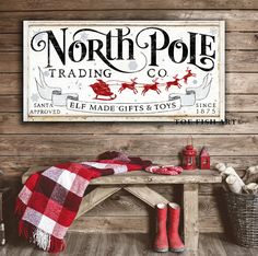 a wooden bench sitting in front of a sign that says north pole trading co on it