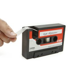 a hand reaching for an old fashioned cassette tape dispenser that is being held by another hand