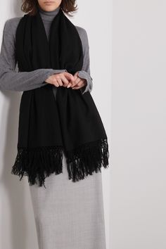 The Row’s ‘Alala’ scarf is made from a wool and cashmere-blend that's cozy, soft and will go with nearly anything. It's minimally designed with fringed edges and has a wide shape that can be knotted at the neck or secured beneath a belt when draped over the shoulders. Wednesday Studios Scarf, Black Tassel Scarf, Black Oversized Scarf, White Cashmere Scarf, Black Wool Scarf, Chanel No 5, Hooded Scarf, Womens Cashmere, Fringe Scarf