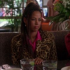 two women sitting at a table in a restaurant with plates and glasses on the table