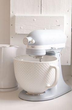 a white mixer sitting on top of a counter