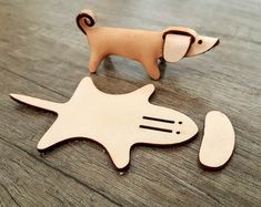 a wooden toy dog standing on top of a table next to an object that looks like a fish