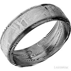 a wedding ring with an intricate design on the outside and inside, in black and white