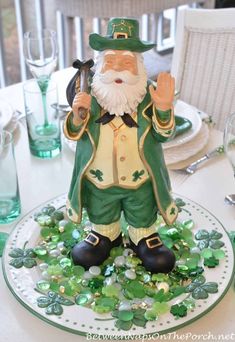 a st patrick's day table setting with a green and gold leprechaun