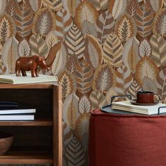 an animal figurine sitting on top of a wooden table next to a book