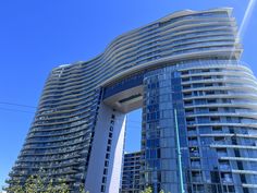 a very tall building in front of a blue sky