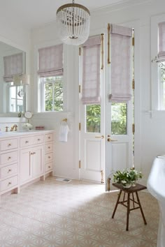 a bathroom with white walls and pink curtains