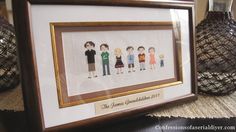 a framed cross stitch picture with four people