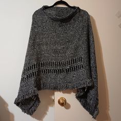 This Brand New Two-Tone Gray & Black Weave Knit Poncho By L.I.B. New York Is Absolutely Stunning! It Has An Overall Striped Pattern With Two Rows Of A Diagonal French Braid Twist Towards The Lower Portion Of The Poncho. The Length From The Shoulder To The Bottom Flaps On Either Side Is 32 Inches. This Poncho Has Been Made With 100% Acrylic. *This Two-Tone Gray & Black Weave Knit Poncho By L.I.B. New York Has Been Placed Carefully Into A New Ziploc Baggie To Keep It Clean.* Thank You For Stopping One Size Gray Knit Sweater, Gray Knit Poncho For Fall, Casual Winter Open Knit Poncho, Casual Black Knit Poncho, Black Knit Casual Poncho, Winter Open Knit Poncho, Casual Gray Knit Poncho, Cozy Oversized Black Poncho, Black Batwing Sleeve Poncho One Size