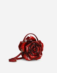 Find DOLCE & GABBANA Resin Rose Design Box Bag on Editorialist. The Dolce & Gabbana Resin Rose Design Box Bag features a press-stud button closure, a top handle, and an adjustable, detachable strap in iguana-print calfskin. It is crafted with a nappa leather lining and comes with special packaging. This bag measures 21 x 22 x 13.5 cm and is made in Italy. Gothic Bag, Rose Bag, Unique Backpacks, Red Clutch, Unique Purses, Gothic Accessories, Statement Bag, Luxury Purses, Dolce E Gabbana