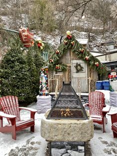 an outdoor fireplace surrounded by chairs and christmas decorations