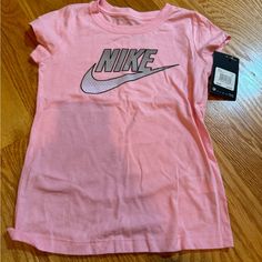 Nike Pink Short Sleeve Tee Nwt Size 6x Fitted Nike T-shirt For Summer, Fitted Short Sleeve T-shirt For Playwear, Basic Tops For Playwear In Spring, Basic Spring Playwear Tops, Basic Spring Tops For Playwear, Fitted Tops With Letter Print For Playwear, Fitted Letter Print Top For Playwear, Cute Short Sleeve Sports Tops, Nike Tops With Logo Print For Spring