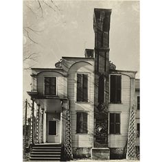 an old house with stairs leading up to it