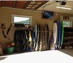 there are many surfboards in this garage