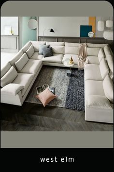 a large white couch sitting on top of a wooden floor