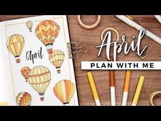 an open notebook with hot air balloons on it and the words, april plan with me