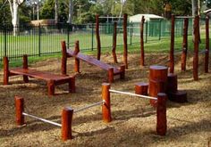 several wooden benches in the middle of a park