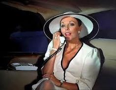 a woman wearing a white hat talking on a phone