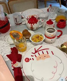 the table is set for christmas dinner with santa's face drawn on the plate