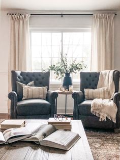 a living room with two couches and a coffee table in front of a window