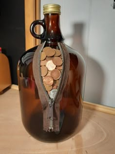 a brown glass bottle with coins in it