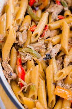 pasta with meat and peppers in a white bowl