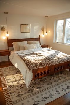 a large bed sitting on top of a wooden floor next to a window in a bedroom