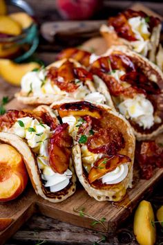 several pita breads on a cutting board with peaches and other fruit in the background