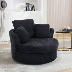 a black chair sitting on top of a white rug