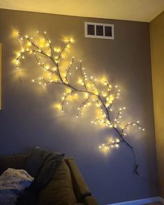 a living room wall decorated with lights and branches