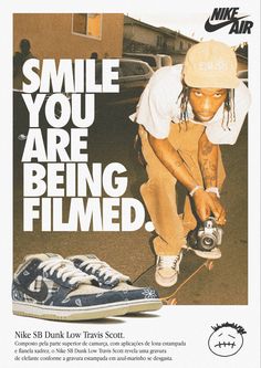 a man riding a skateboard next to a pair of blue and white shoes with the words smile you are being filmed